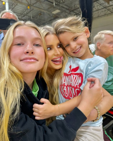 CHEER SQUAD: Jessica Simpson (center) roots for son Ace, 11, as he plays basketball, with daughters Maxwell (left), 12, and Birdie, 5, by her side.