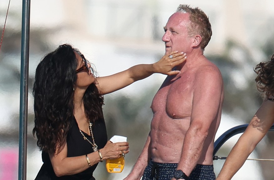 HERE'S THE RUB: Salma Hayek helps out hubby François-Henri Pinault while yachting in Ibiza, Spain.