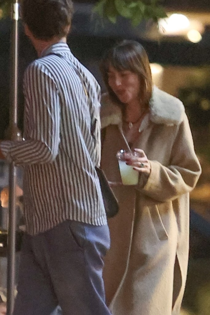 Dakota Johnson smiling while out with friends in Malibu on Friday.